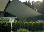 Szary żagiel wodoszczelny premium 3x2,5m zamontowany nad tarasem w ogrodzie, osłaniający przed słońcem i deszczem.