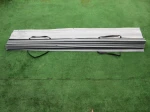 Szara pozioma roleta rzymska PVC o wymiarach 3,80x3,39 m, złożona i gotowa do montażu na tarasie lub pergoli.